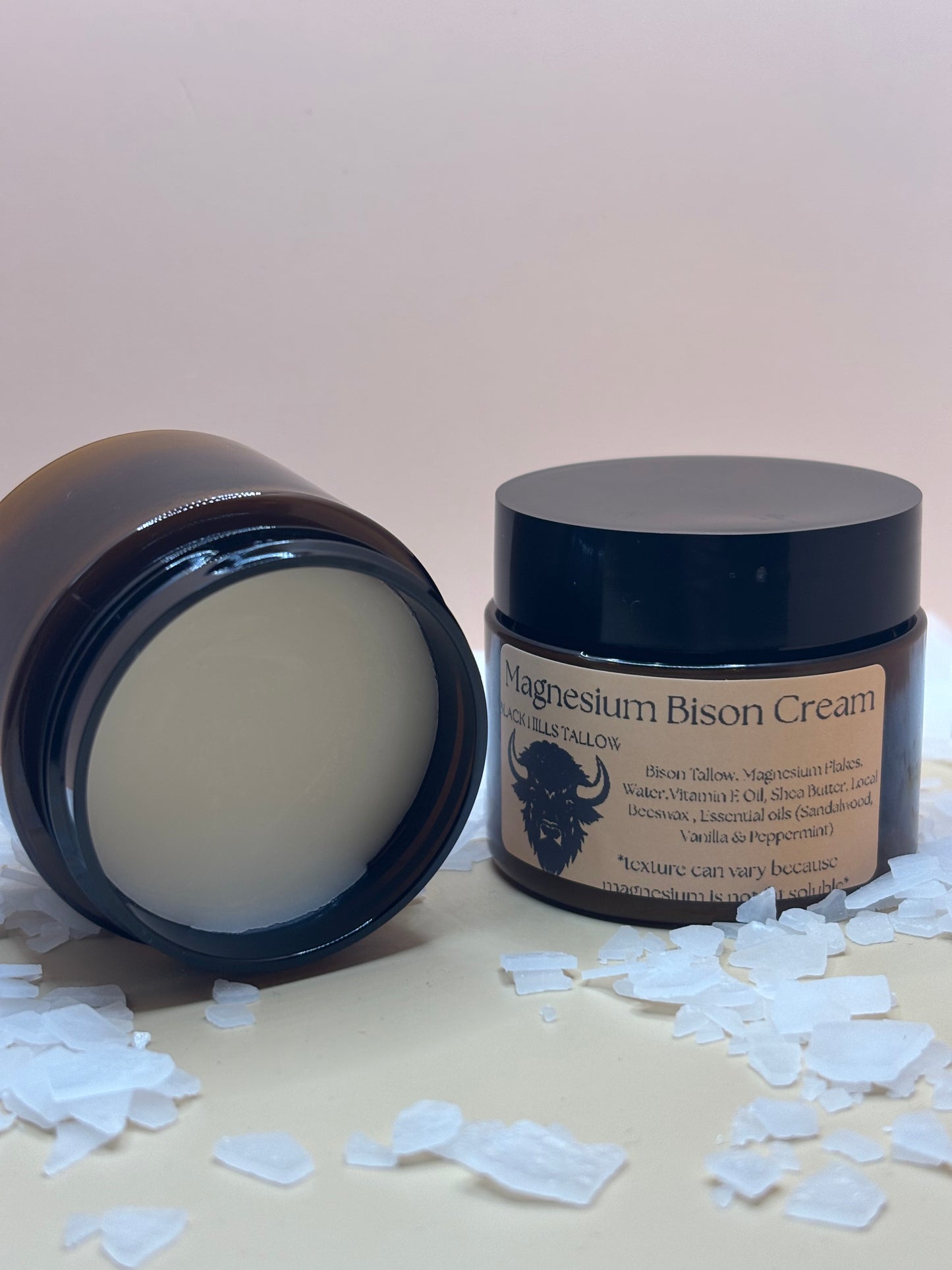 Bison Cream jar with lid off on a light background