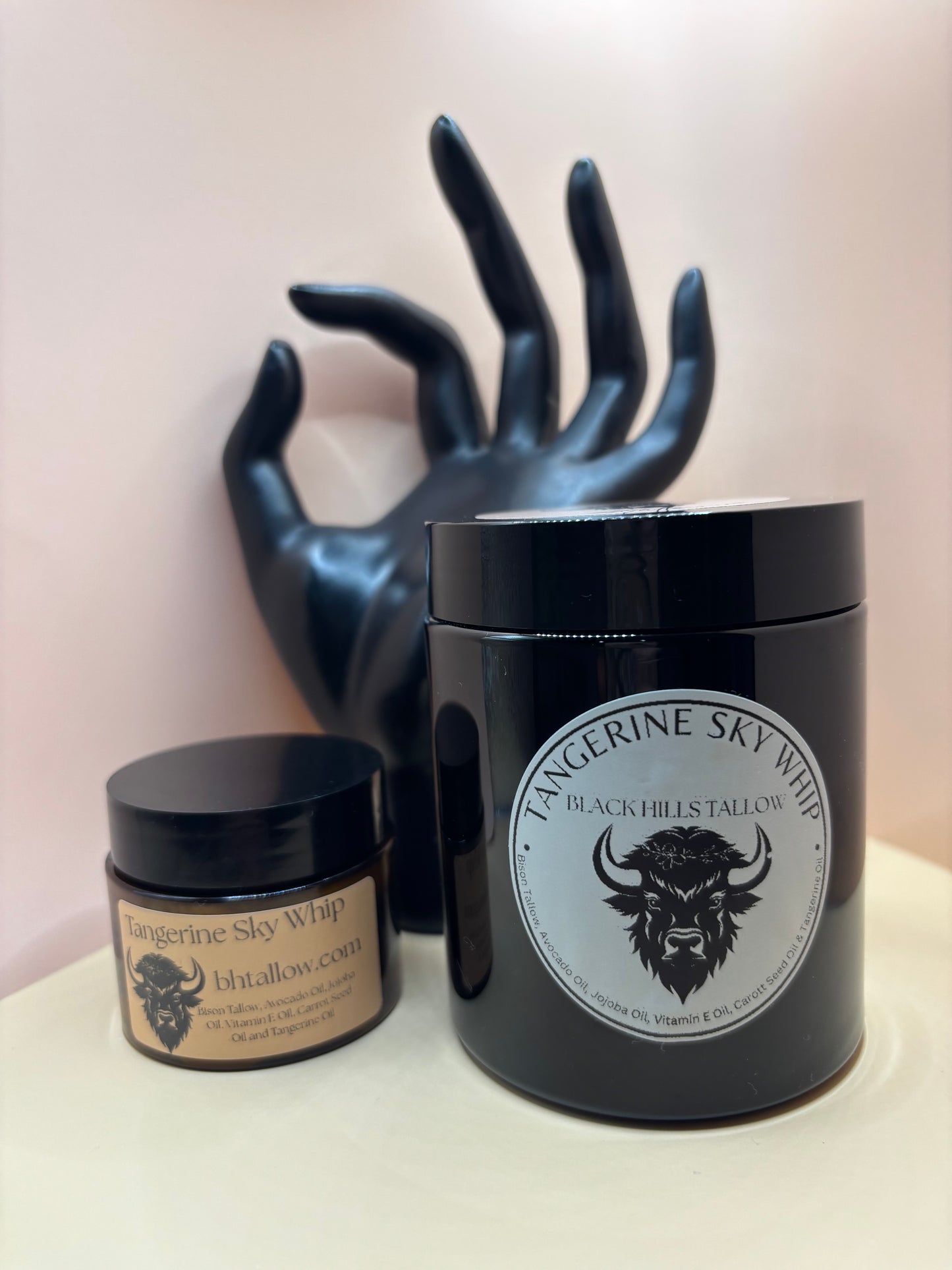 Black grooming tool with a branded container on a light background