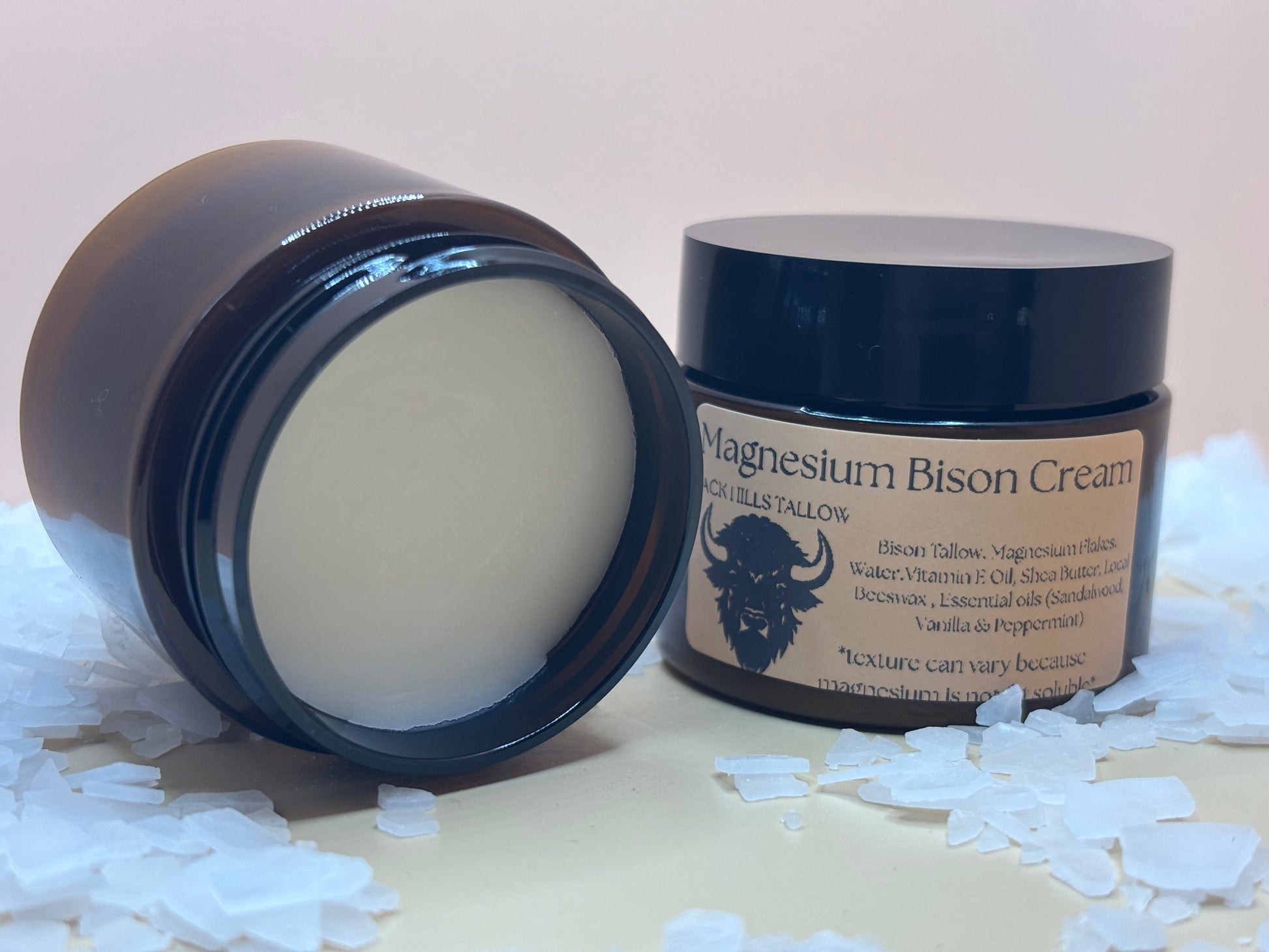 Two containers of Magnesium Bison Cream on a white background