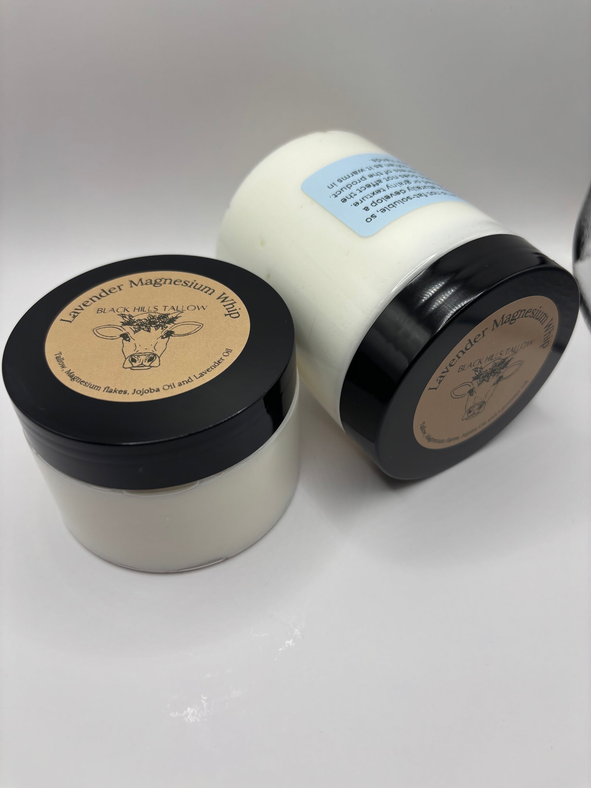 Two jars with black lids on a white background