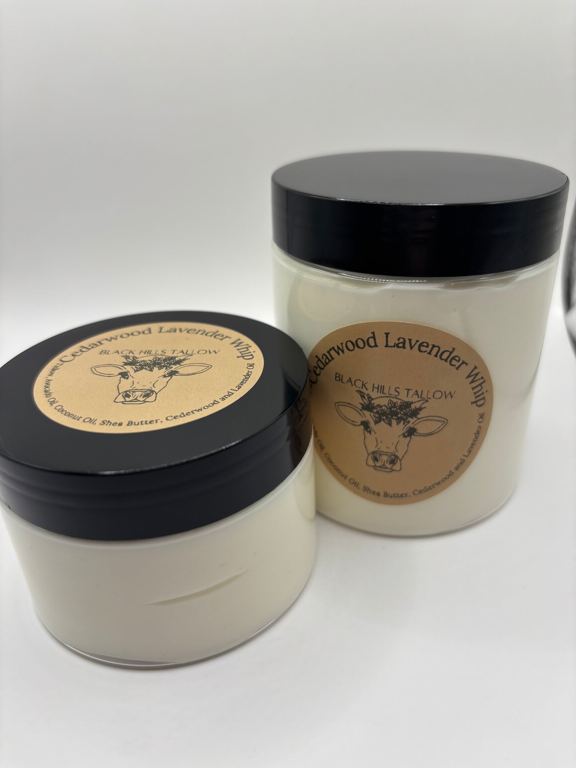 Two containers with black lids and visible branding on a white background